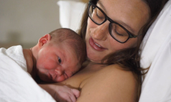 A new mother cuddles her baby.