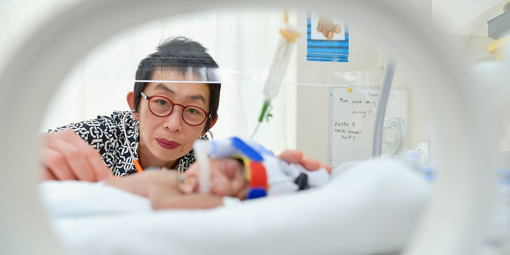 Professor Jeanie Cheong with newborn