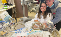 Sky and Trisdan with baby Remi in the Women’s NICU before the twins passed away.