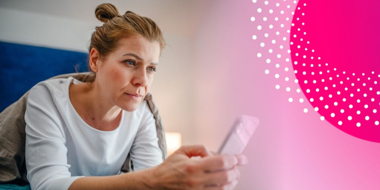Woman looking sceptically into her phone. 